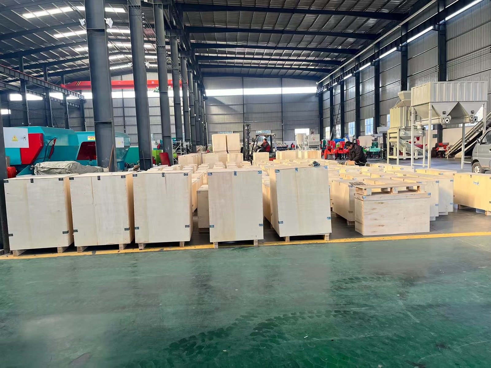 Complete pellet production line system showing crusher mixer pellet mill cooler and packaging equipment in industrial setting